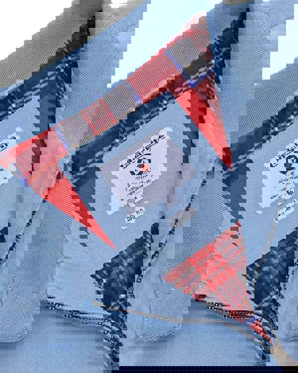 Lambretta Mens Showerproof Classic Harrington MOD Scooter Jacket Coat, close-up of the inside labeling and red tartan lining with light blue exterior fabric.