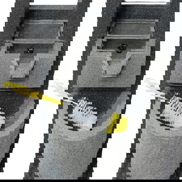 Gray electric water feature with a textured finish, featuring a built-in basin and a yellow cleaning brush resting inside