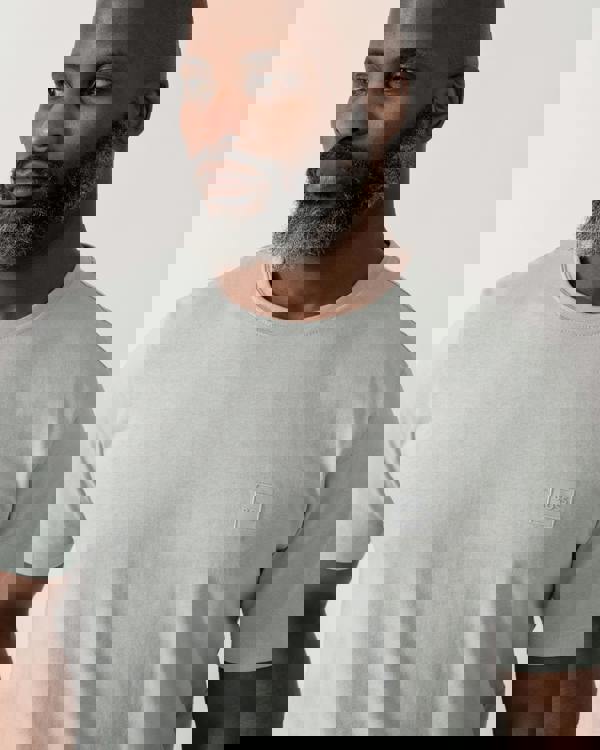 detail shot of a model wearing a BOSS Orange Tales Mens Cotton-Jersey T-shirt With Logo Patch in Silver