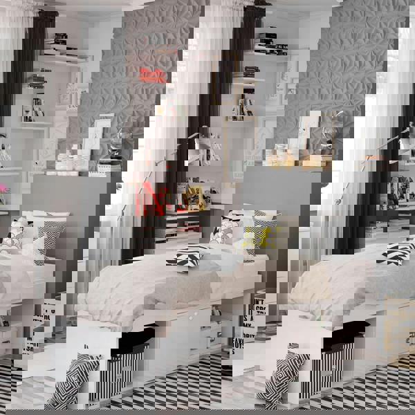 White bed frame in a modernly decorated bedroom.