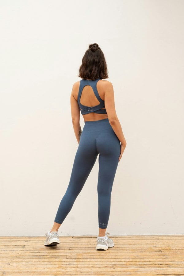 Blue recycled supportive sports bra and high waisted cropped leggings.