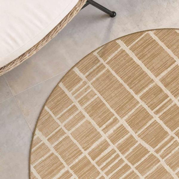 Round beige and white checkered rug on a tiled floor