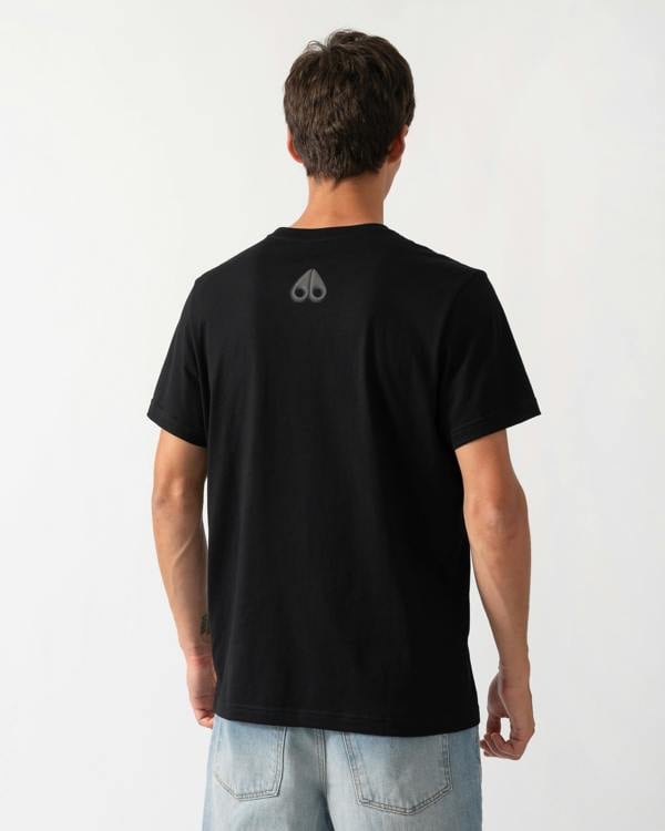 back of a model wearing a Moose Knuckles Mens Shadow Logo T-Shirt in Black 292