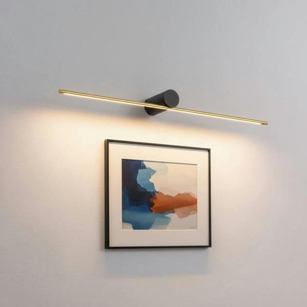 gold led picture lamp mounted on the wall above a modern picture