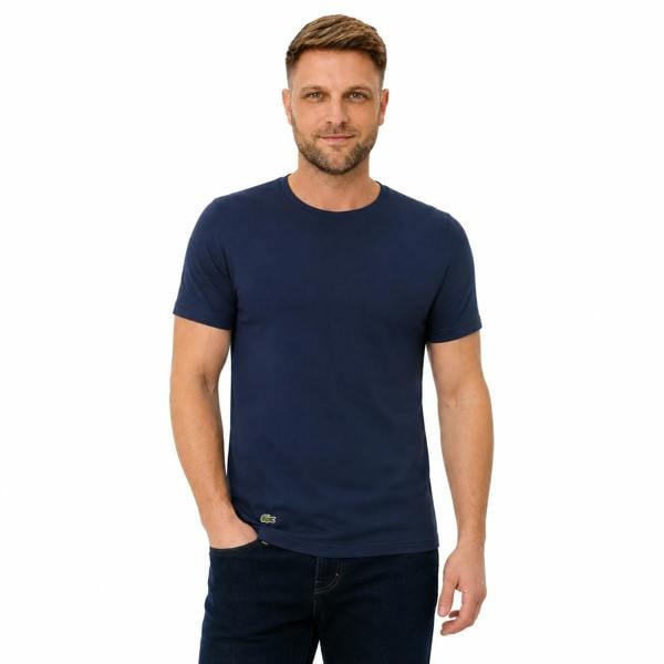 Man wearing a navy blue Lacoste cotton lounge t-shirt with a small crocodile logo.