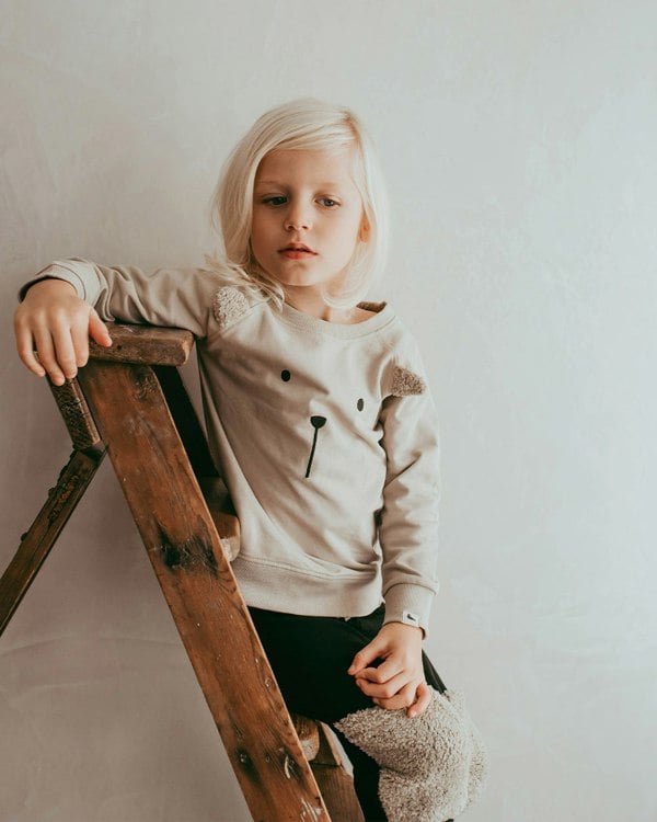 Boy wearing unisex organic cotton kids long-sleeve sweatshirt