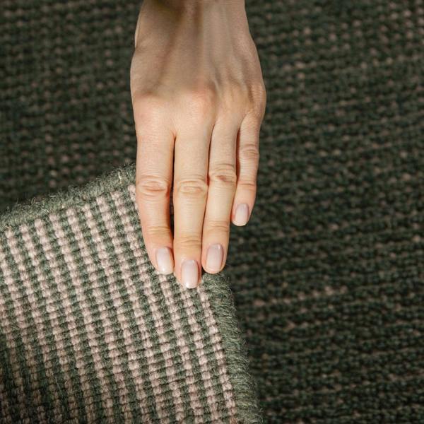 Hand resting on a textured fabric surface