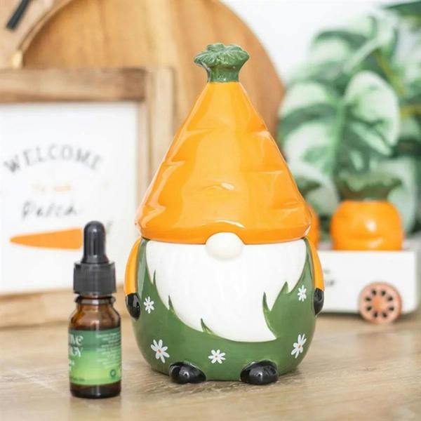 Ceramic oil burner with orange cone top and green base, white leaf motif and feet