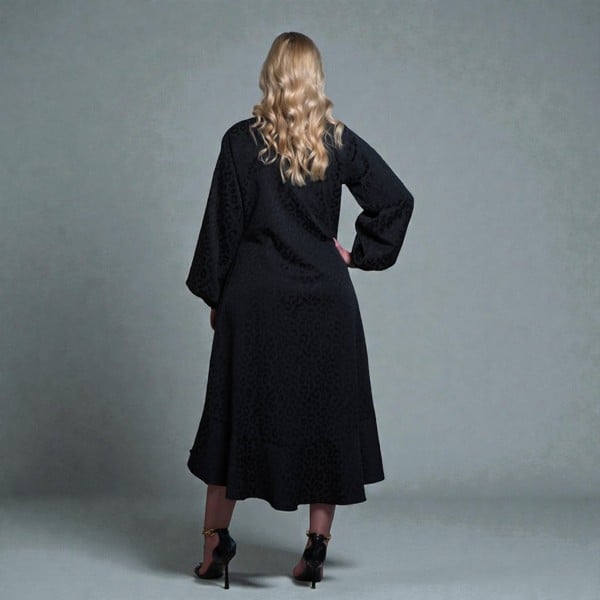 Women's Aphrodite Black Leopard Jacquard Dress, styled with black heels for a chic, coordinated look.