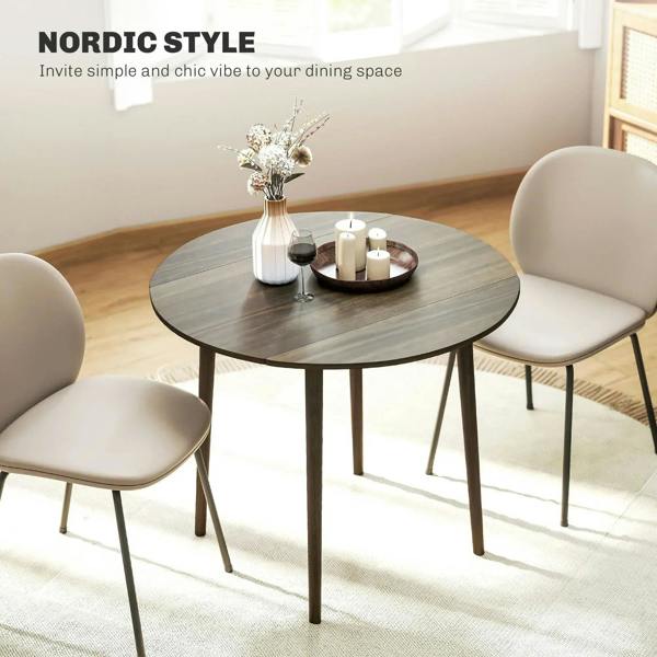 Grey round drop-leaf dining table with wood legs, minimalist Nordic dining setup