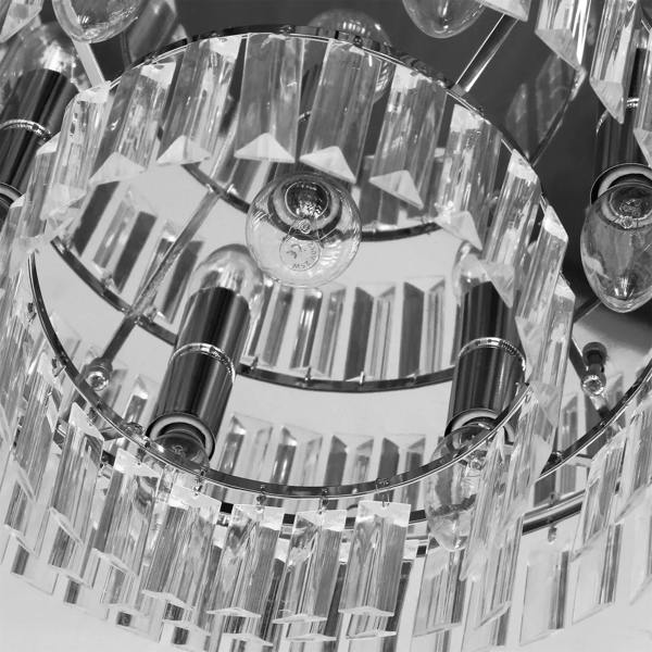 Close-up of silver crystallite chandelier canopy with clear crystal rods and bulb holders