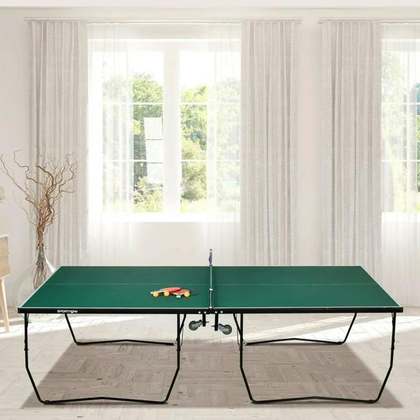 Green folding tennis table with net in an indoor room, ready for play