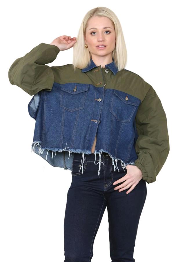 Woman wearing a two-tone jacket with green sleeves and blue denim front on a beige background