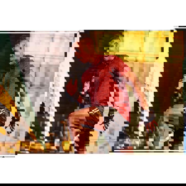 Man running outdoors with the adidas 1.5kg ankle/wrist weights