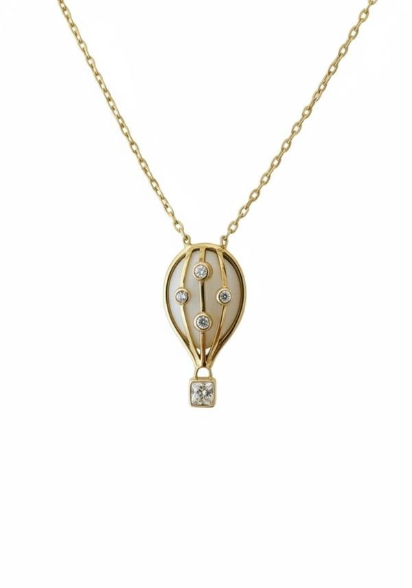 Gold necklace with a hot air balloon pendant on a white background