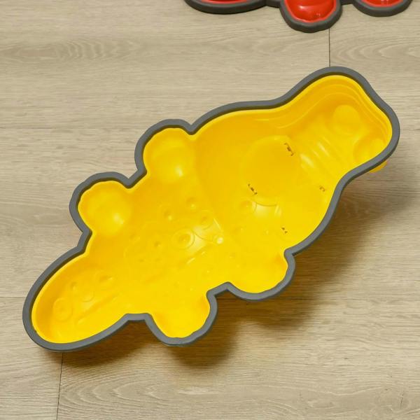 Yellow crocodile stepping stone on a wooden floor with textured non-slip edges