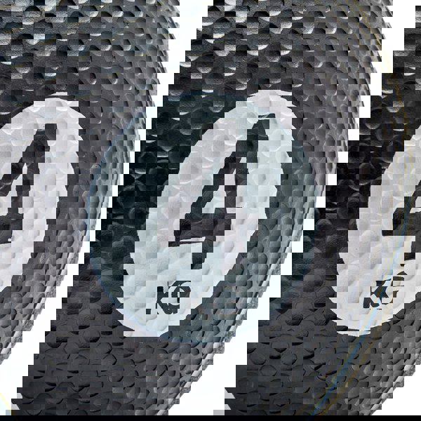 Black medicine ball with '4 KG' marking on a white background