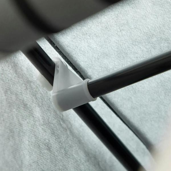 Light grey fabric wardrobe shelf support bar with connector clip, close-up.