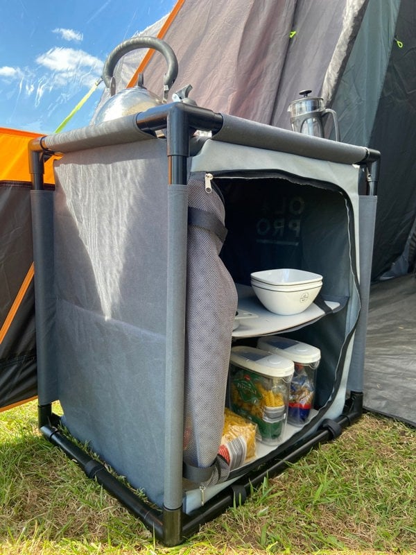 An image of the Camp Storage Cupboard from OLPRO being used as storage for food and cutlery.