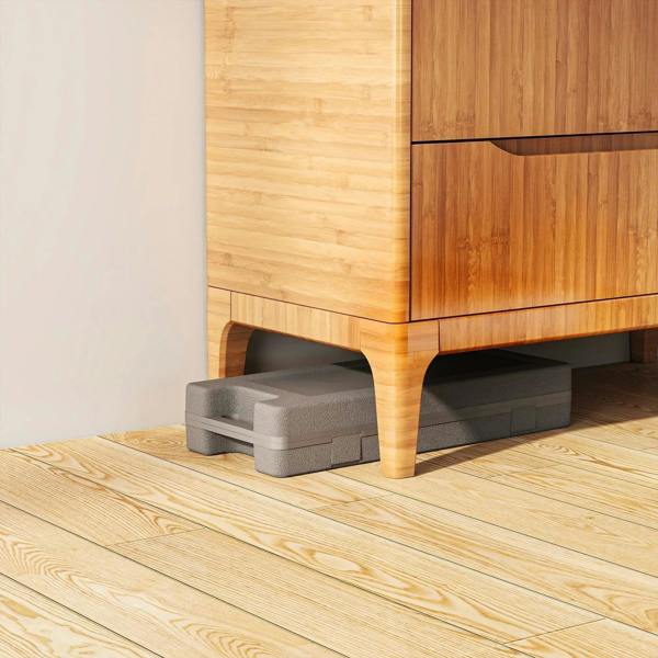 Gray dumbbell storage case placed on wooden floor near furniture
