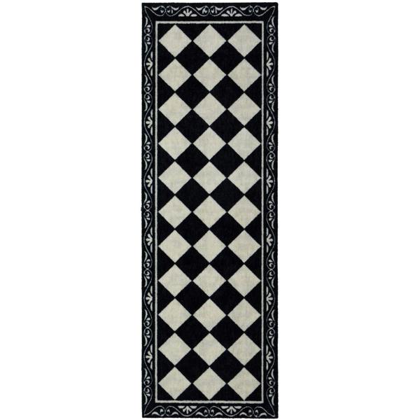 Black and white checkered rug with decorative border on a white background