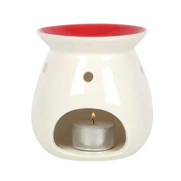 Ceramic wax melt burner with red rim and open center holding a lit tea light