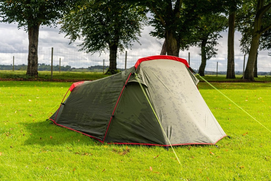 The OLPRO Beckford Lightweight 2 Person Tent (Ripstop) pitched in a field with its doors closed.