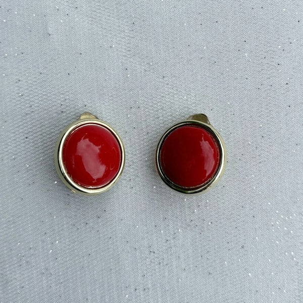 Red and gold clip-on earrings, round dome design, glossy red centre, gold-tone border, bold statement jewellery, vintage-inspired accessory
