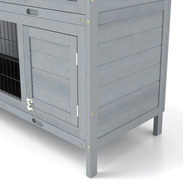 Close-up of grey side door panel on outdoor rabbit hutch with latch and handle