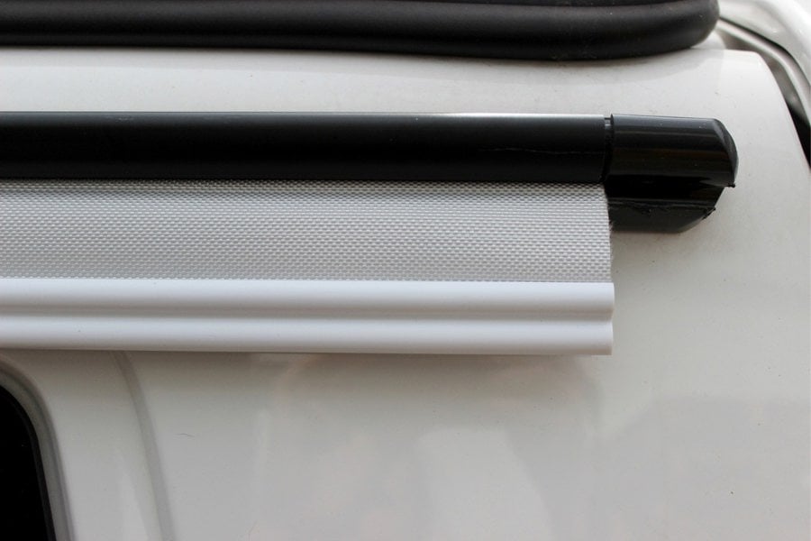 The OLPRO 6-6mm Awning Drive Away Kit attached to an awning rail on a campervan awning, showing the Kador strip and figure of 8.