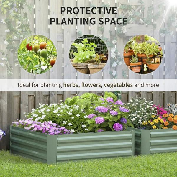 Green raised garden bed planter box with blooming flowers along the front