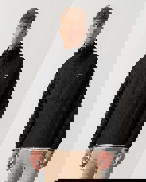 Model wearing Lacoste Lightweight Packable Water-Repellent Ripstop Jacket in Black 031 - Main