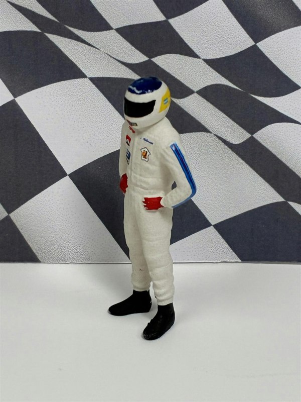 a toy figure in a white suit