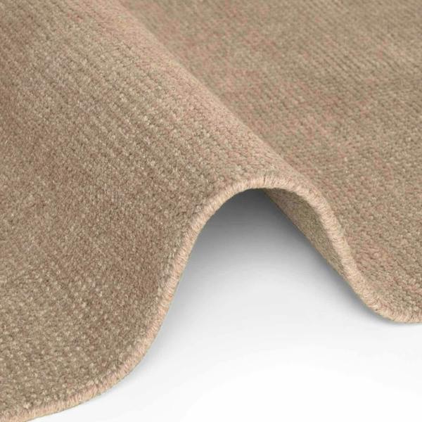 Close-up of beige carpet texture on a white background