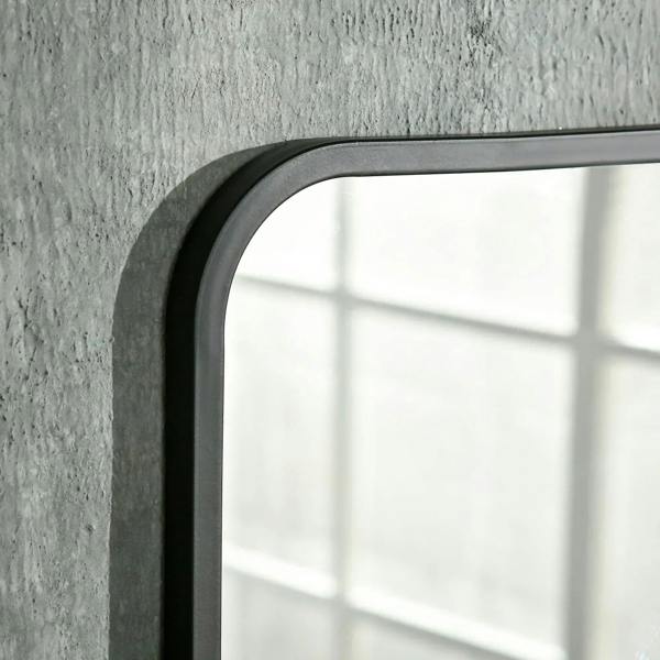 Black mirror frame corner with rounded edge and dark mounting lip