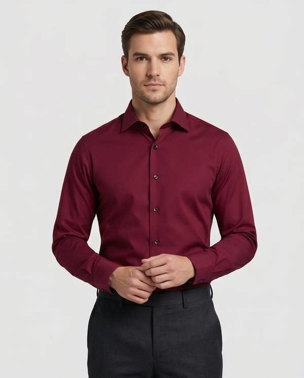 Man wearing a burgundy dress shirt against a plain background