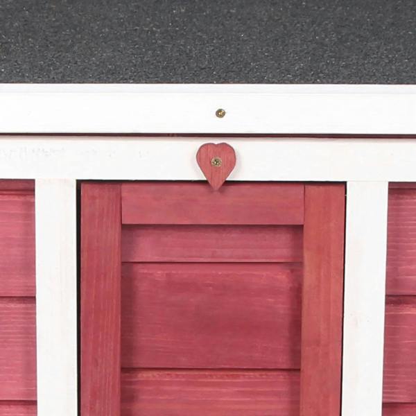 Red wooden rabbit hutch close-up of door opening with heart-shaped latch