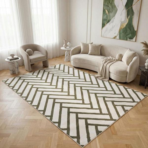 Living room with a geometric patterned rug, beige sofa, and armchair.