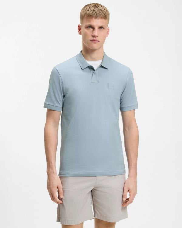 Model wearing BOSS Orange Passenger Mens Stretch-Cotton Slim-Fit Polo Shirt with Logo Patch in Light/Pastel Blue 458 - Front
