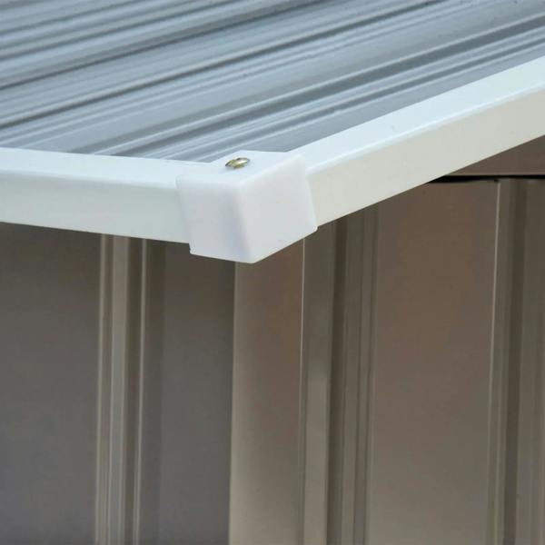 Metal shed roof corner with white trim cap and fastener detail