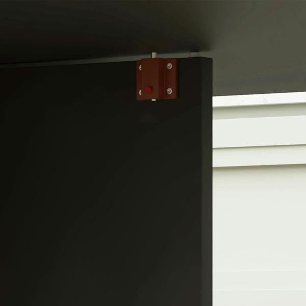 Black drop-leaf dining table hinge latch on the underside frame