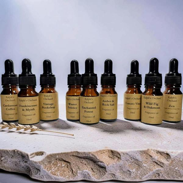 Row of small bottles with droppers on a textured surface