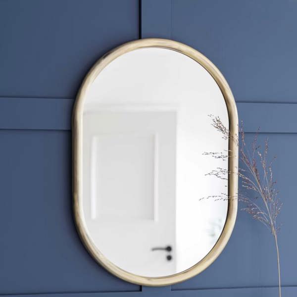 An antique brass arched wall mirror styled above a vintage washbasin bathroom vanity by Abode Home & Gifts.
