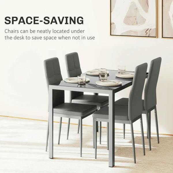 Grey glass-top dining table with four faux-leather chairs, space-saving arrangement