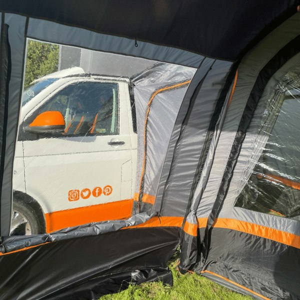 An image of the inside of the OLPRO Charcoal & Orange Cocoon Breeze Campervan Awning Extension attached to the Cocoon Breeze that has been fixed to a VW Campervan.