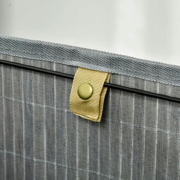 Grey bamboo laundry basket with lid, close-up of lining strap and button