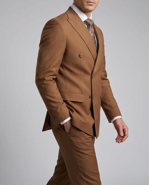 Brown suit worn by a person on a gray background