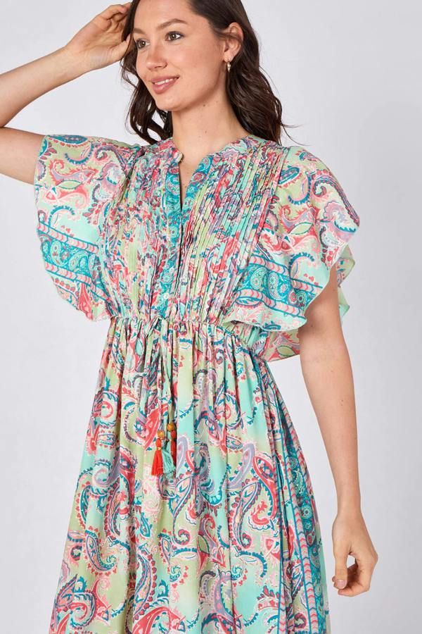 Woman wearing a colorful patterned dress on a white background