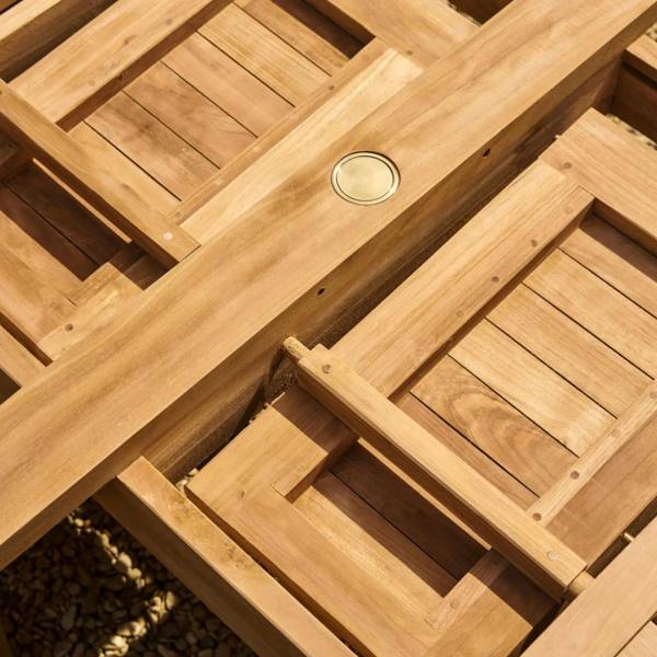 Side view of the teak table underframe showing the extension tracks and sturdy H-frame base.