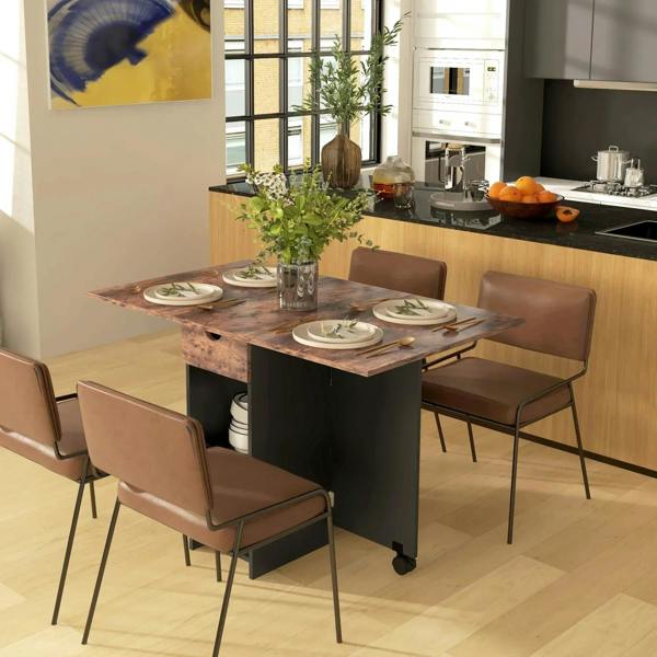 Rustic brown folding dining table with drawer front, set for dining with chairs.